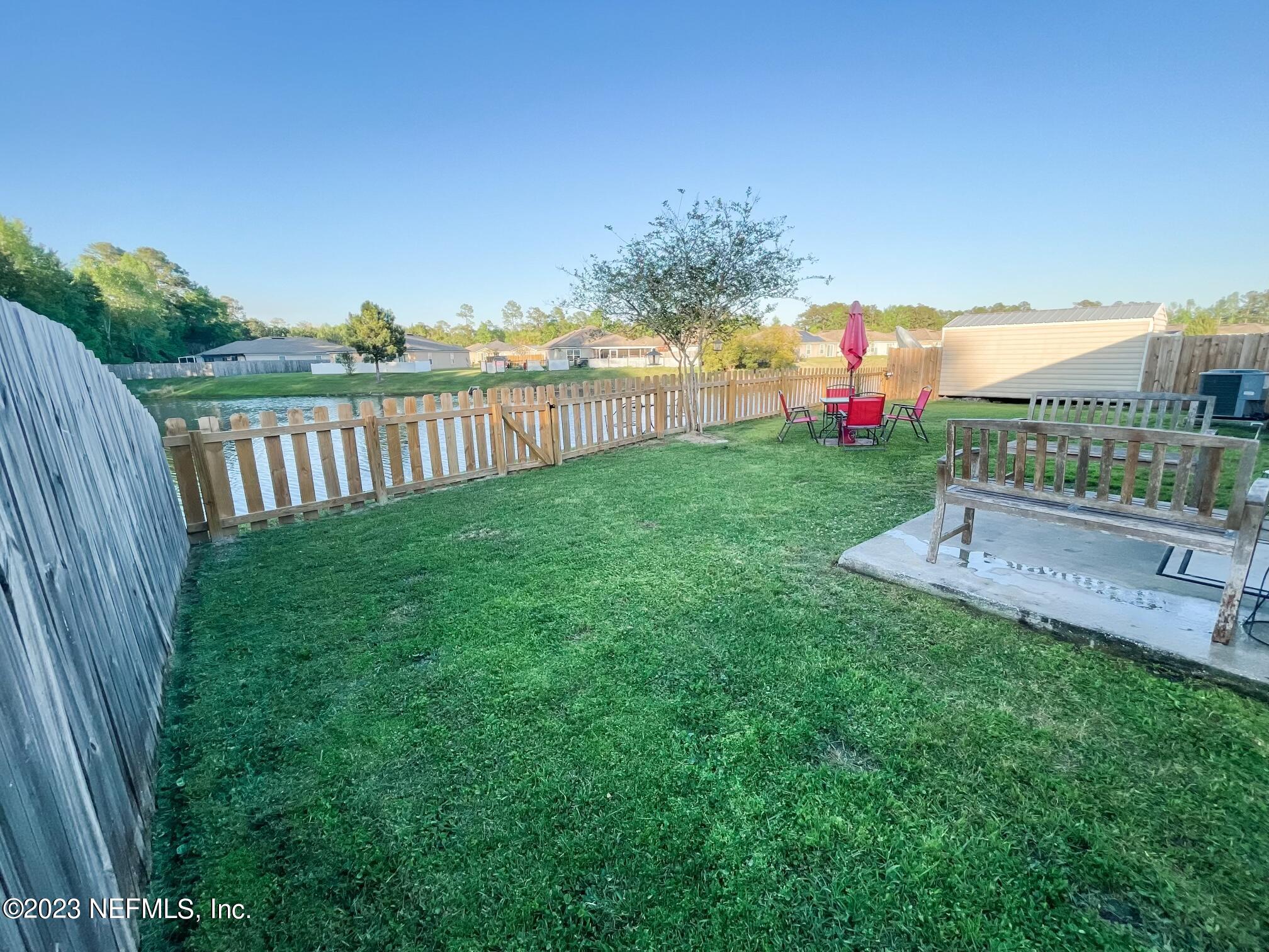 45190 Dutton Way Callahan, FL 32011 - Photo 26 of 29 a view of a garden with houses in back