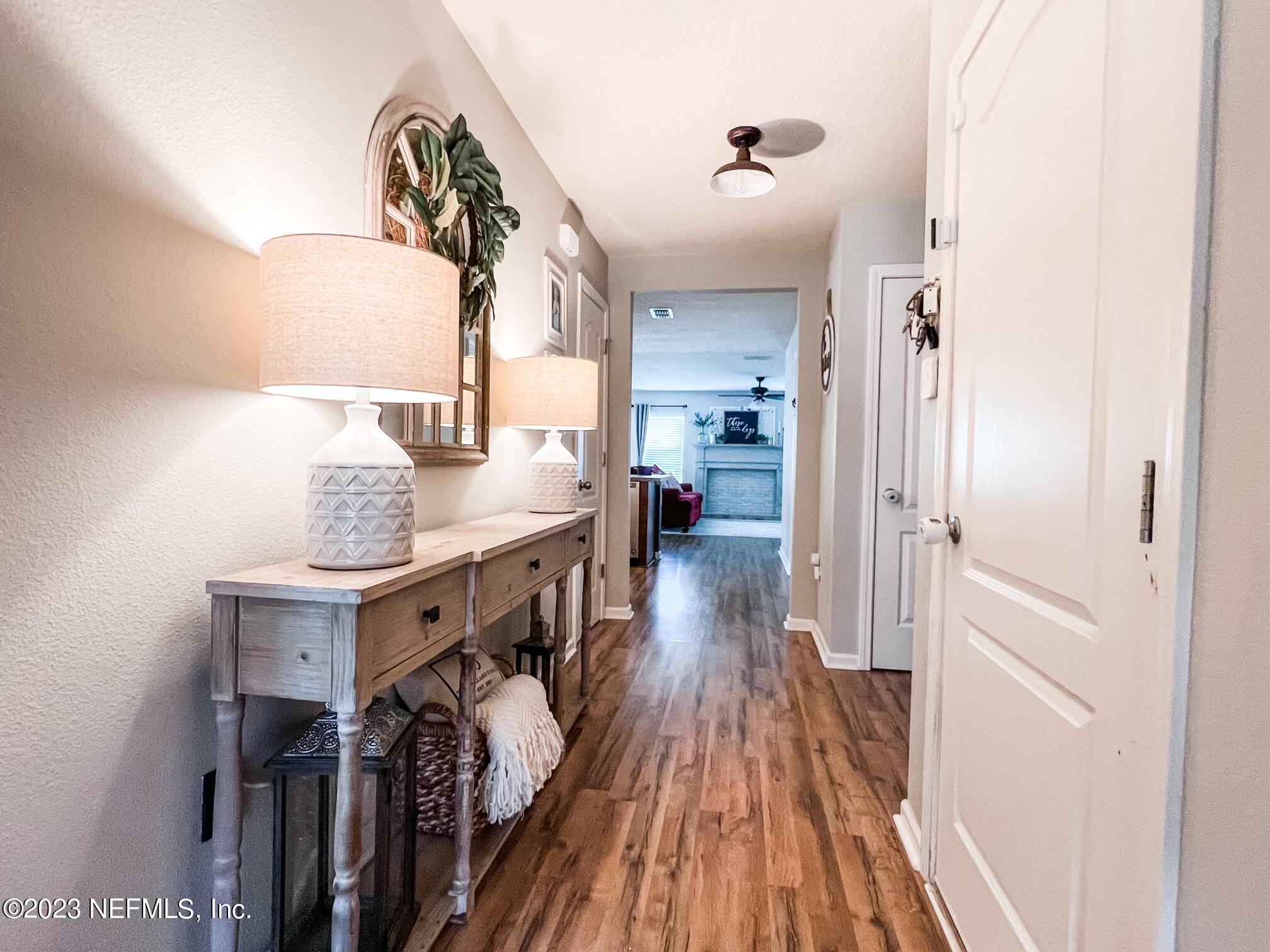 45190 Dutton Way Callahan, FL 32011 - Photo 3 of 29 a view of entryway and hall with wooden floor