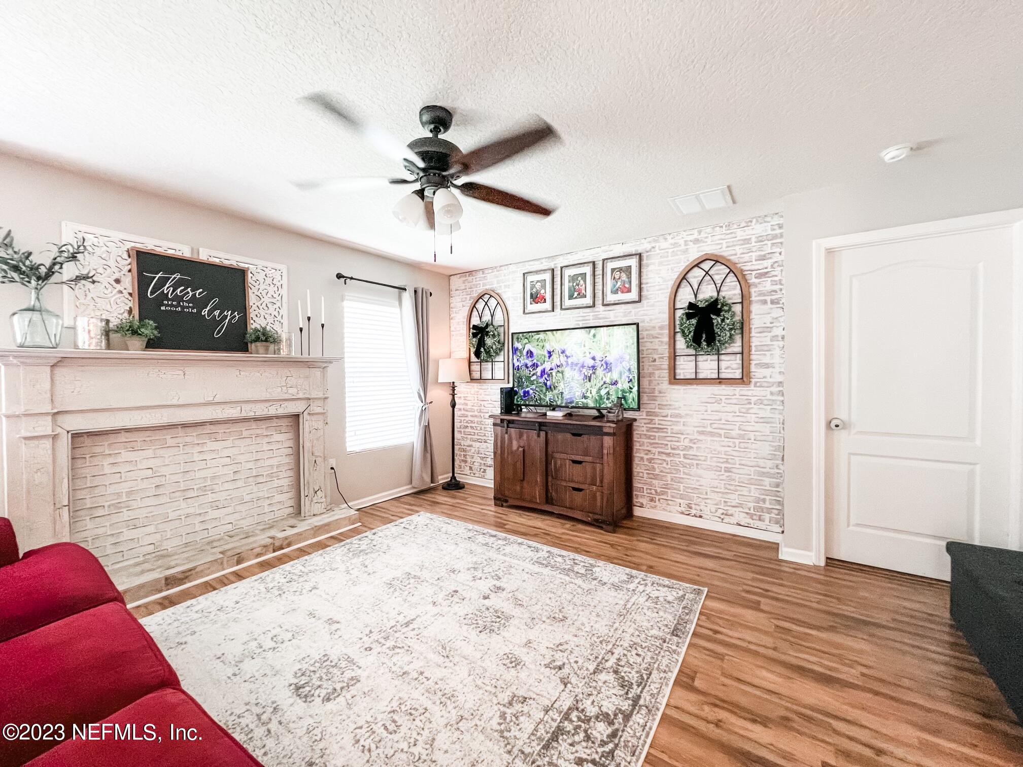 45190 Dutton Way Callahan, FL 32011 - Photo 9 of 29 a view of a livingroom with wooden floor and a ceiling fan
