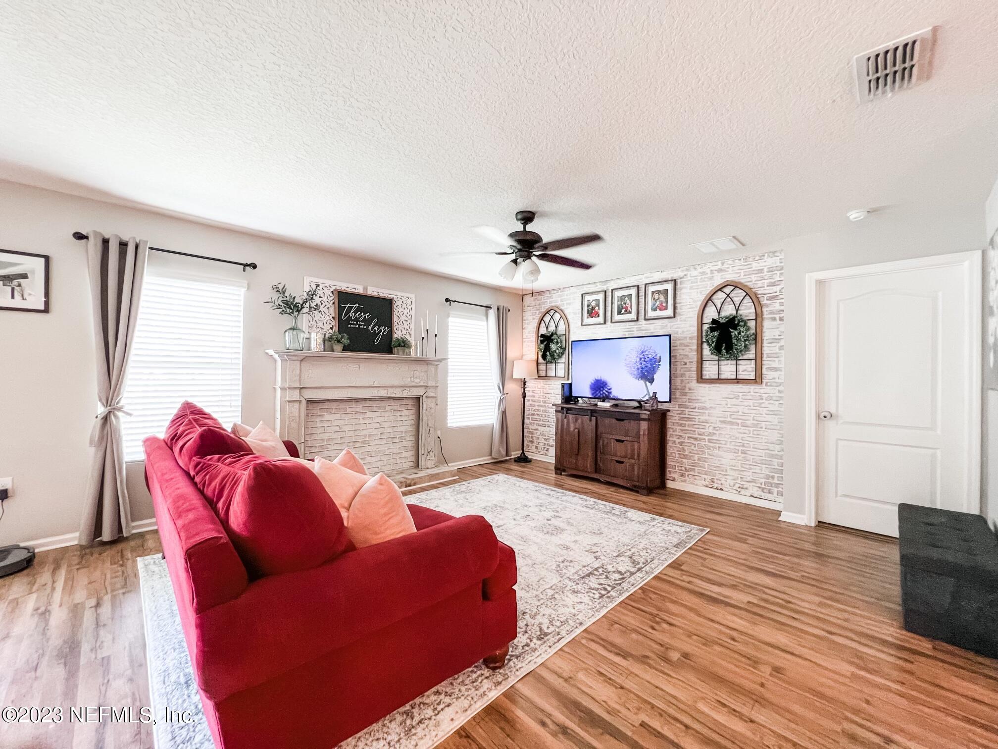45190 Dutton Way Callahan, FL 32011 - Photo 10 of 29 a living room with furniture and a wooden floor