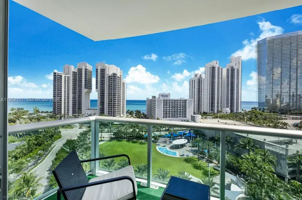 a view of a city with tall buildings and a big yard