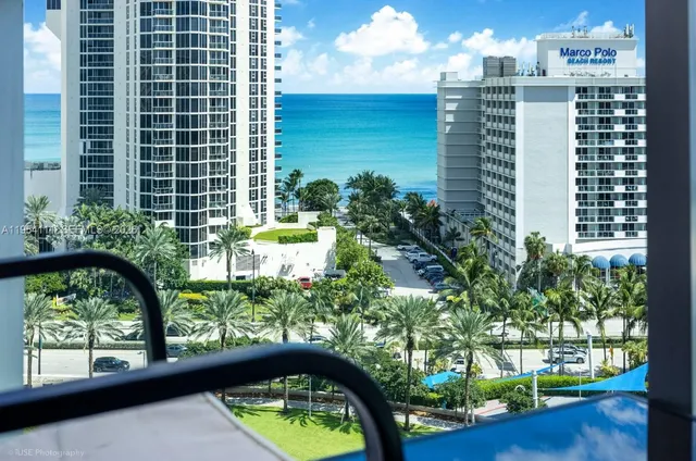 a view of a balcony with a yard