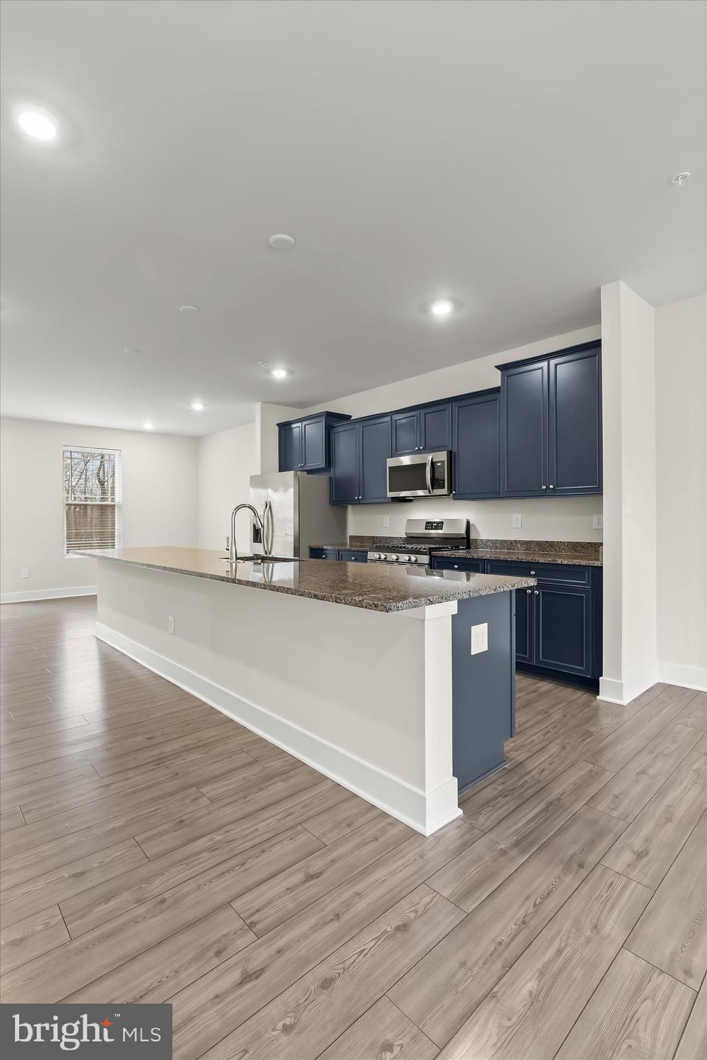 304 Sweetbay Road Essex, MD 21221 - Photo 11 of 66 a large kitchen with stainless steel appliances granite countertop a large counter top and a stove top oven