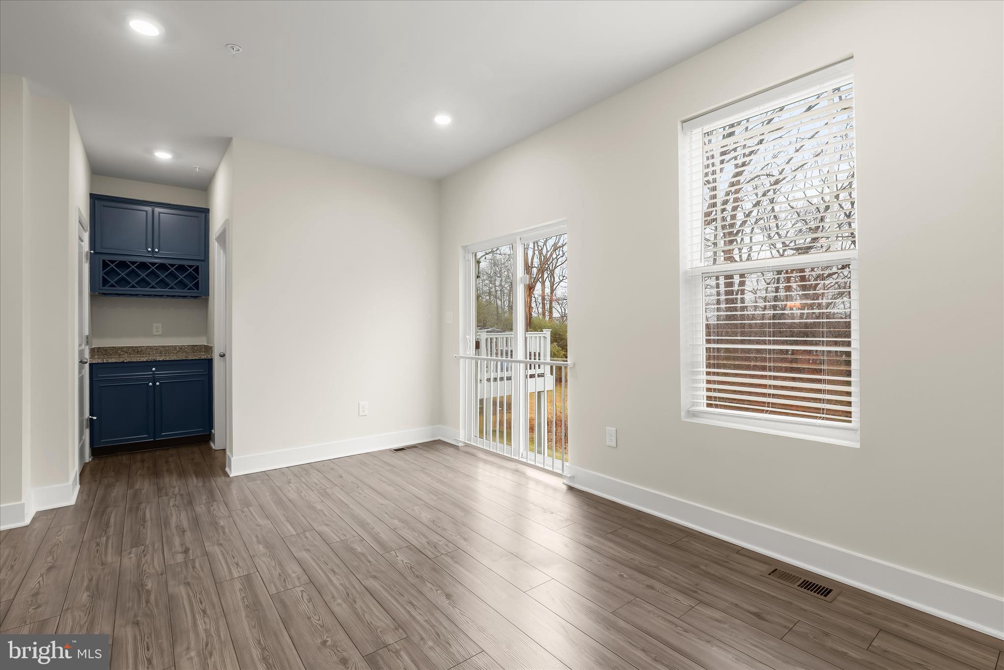 304 Sweetbay Road Essex, MD 21221 - Photo 15 of 66 a view of an empty room with a window and wooden floor