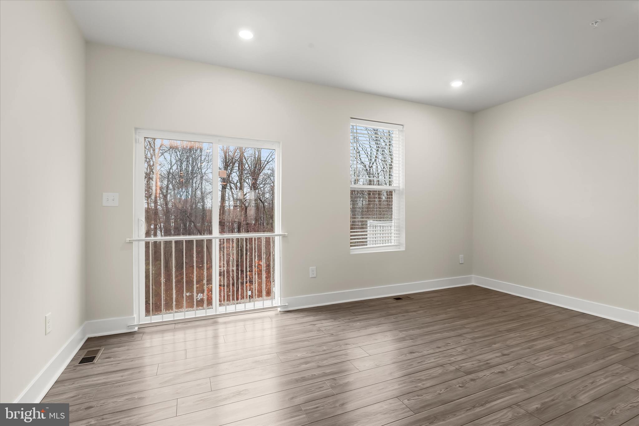 304 Sweetbay Road Essex, MD 21221 - Photo 16 of 66 an empty room with wooden floor and windows