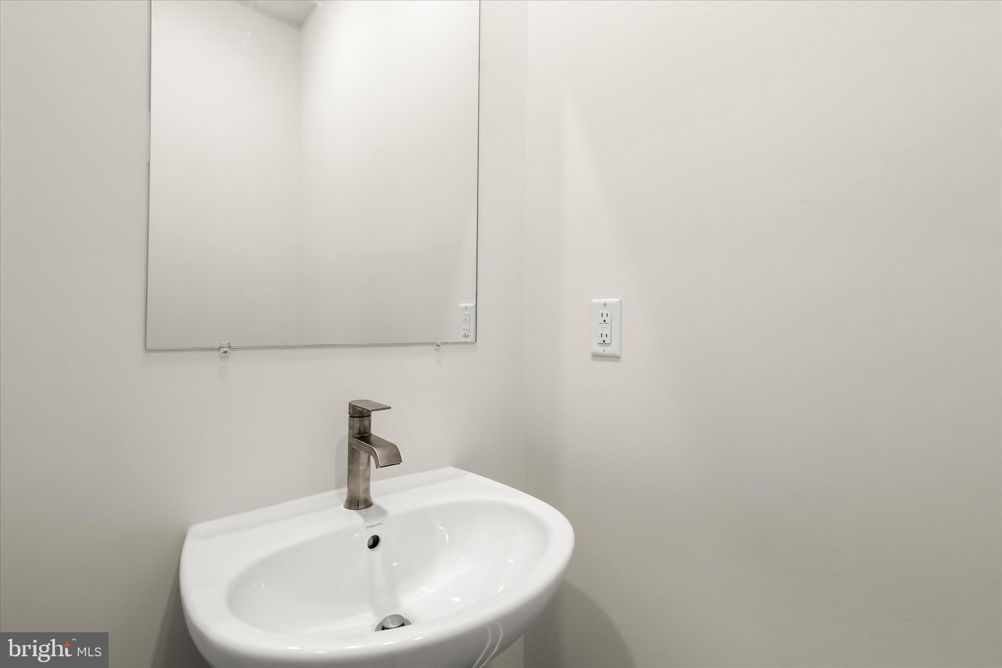 304 Sweetbay Road Essex, MD 21221 - Photo 17 of 66 a bathroom with a sink and a mirror