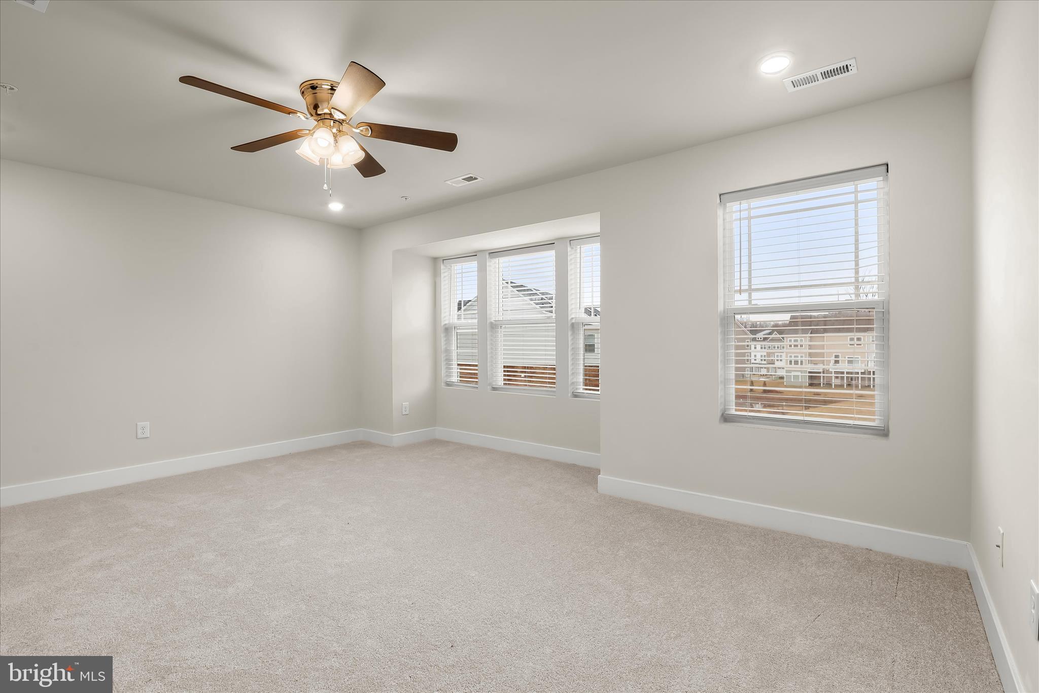 304 Sweetbay Road Essex, MD 21221 - Photo 19 of 66 an empty room with windows and fan