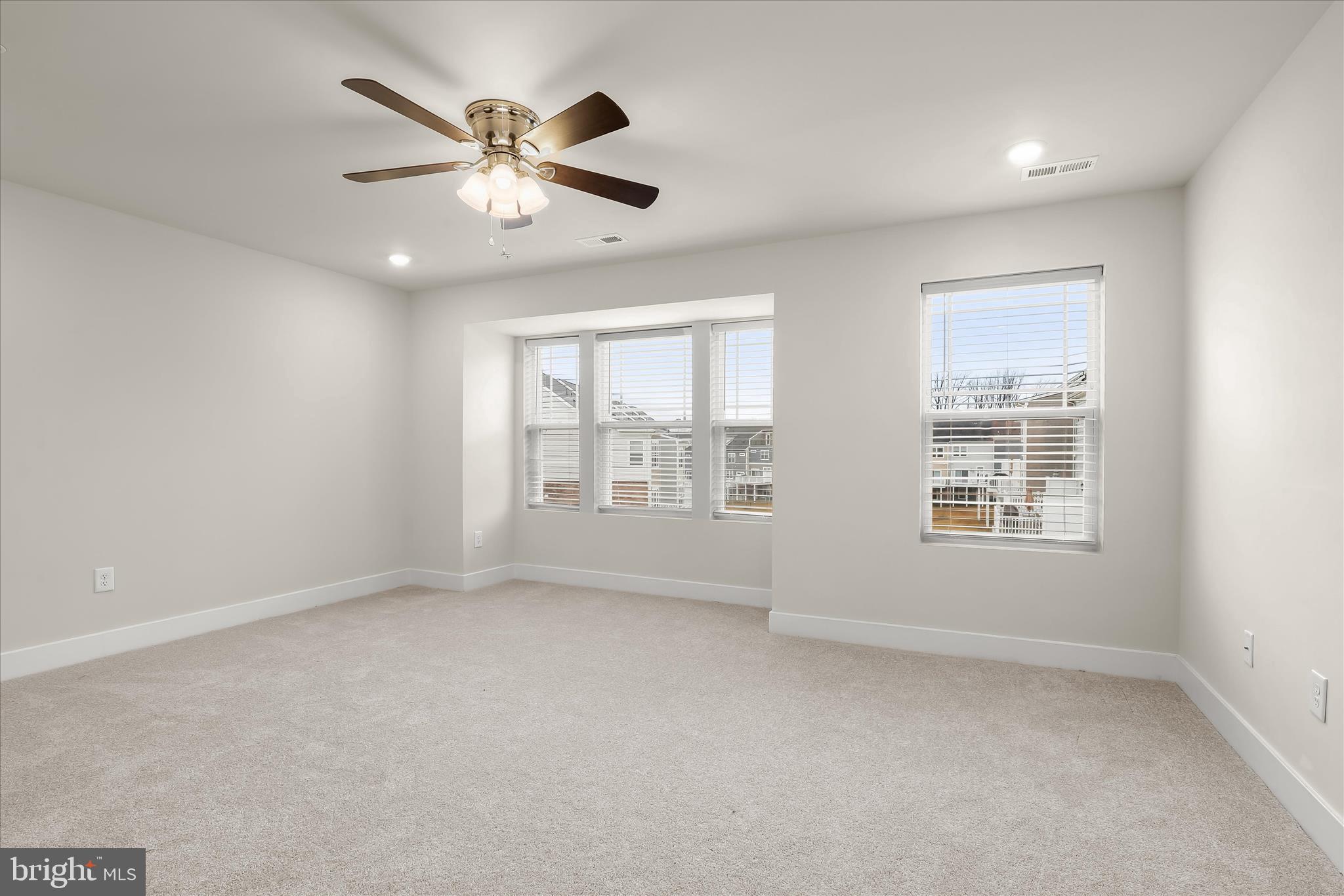 304 Sweetbay Road Essex, MD 21221 - Photo 20 of 66 an empty room with chandelier fan and windows
