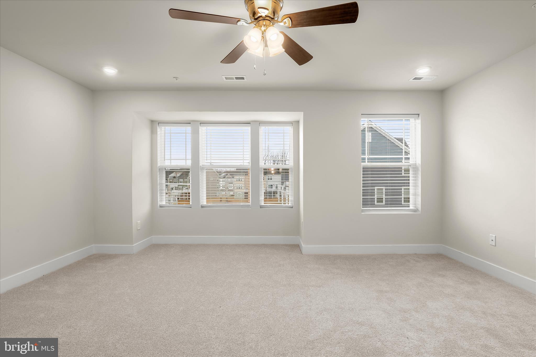 304 Sweetbay Road Essex, MD 21221 - Photo 21 of 66 an empty room with chandelier fan and windows
