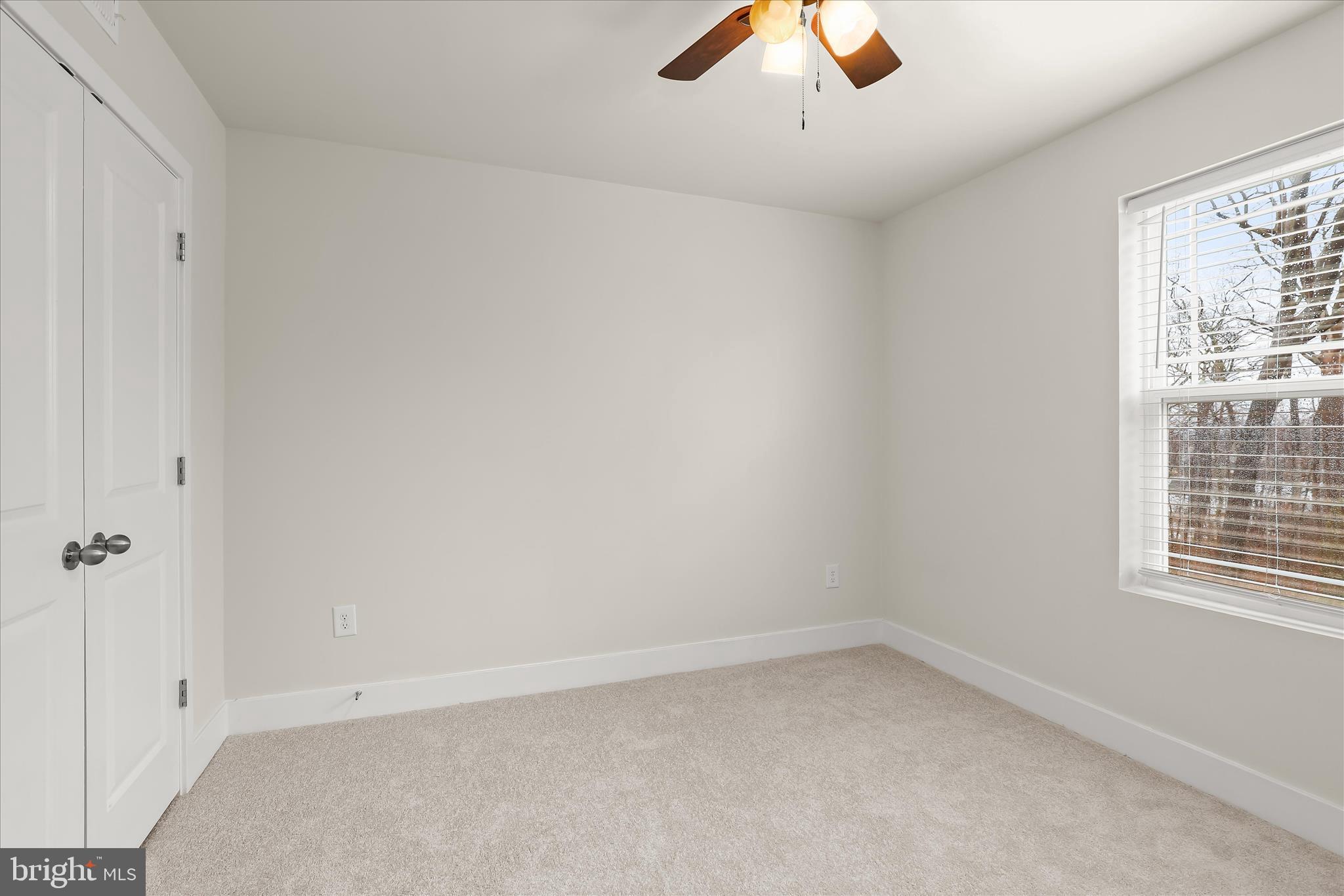 304 Sweetbay Road Essex, MD 21221 - Photo 27 of 66 an empty room with a window and ceiling fan