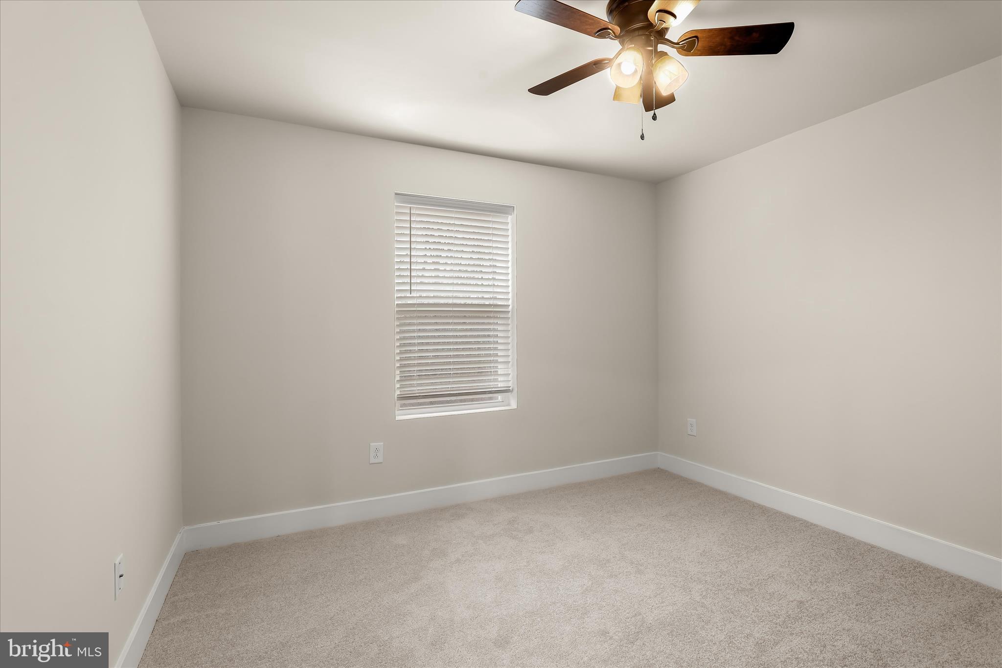 304 Sweetbay Road Essex, MD 21221 - Photo 28 of 66 an empty room with a window and a fan