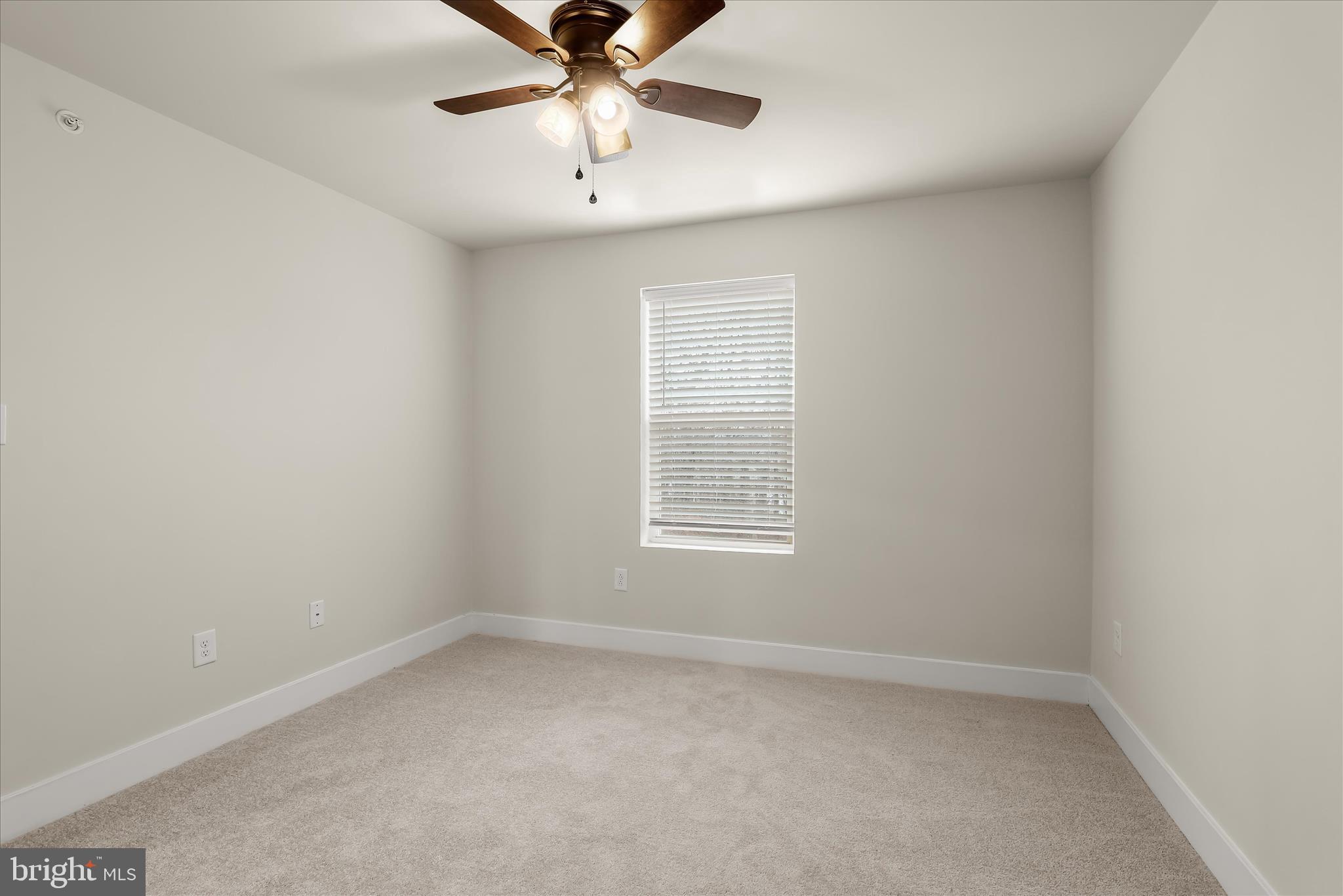 304 Sweetbay Road Essex, MD 21221 - Photo 29 of 66 an empty room with a window and a fan