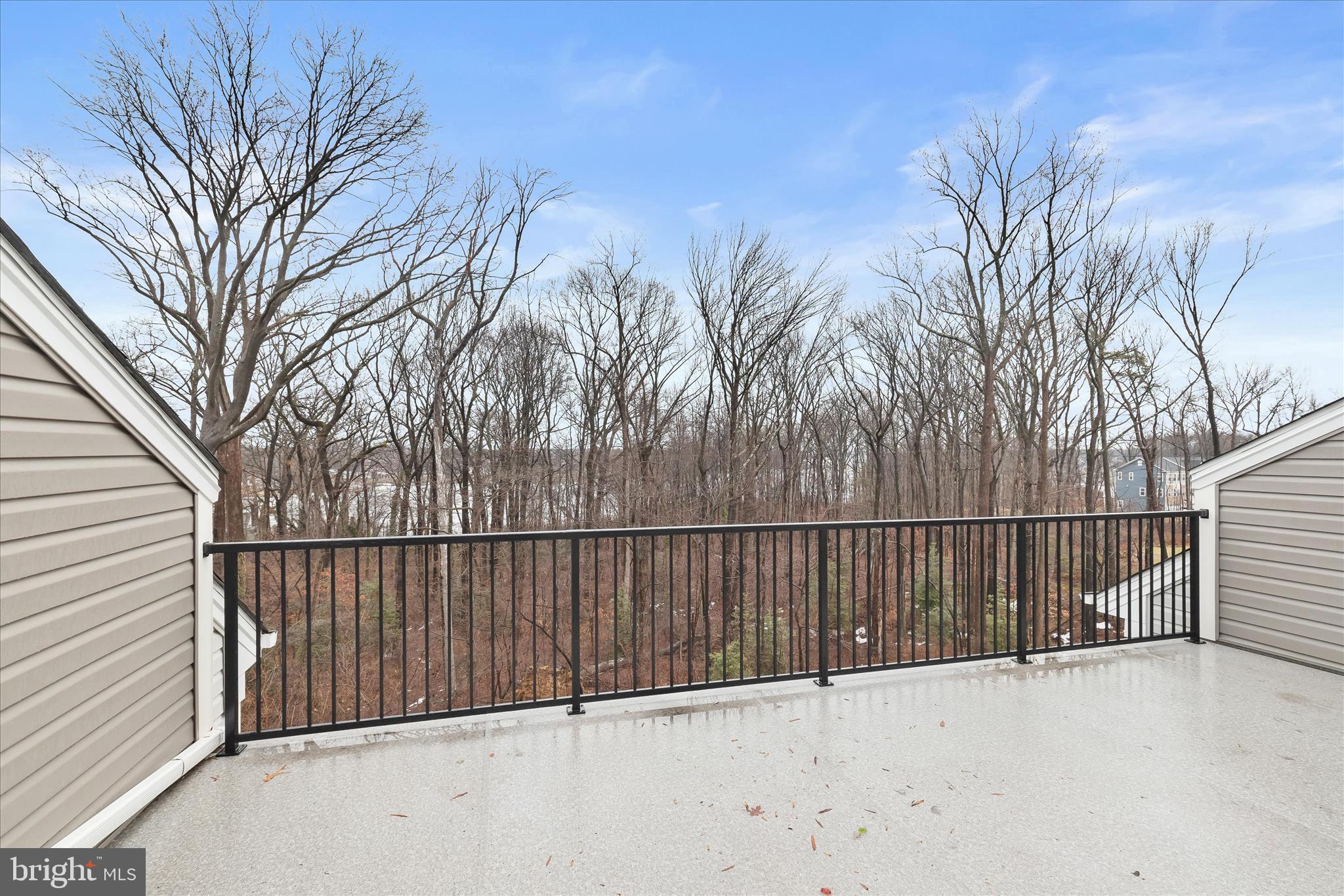 304 Sweetbay Road Essex, MD 21221 - Photo 36 of 66 a view of a roof deck with wooden fence and large trees