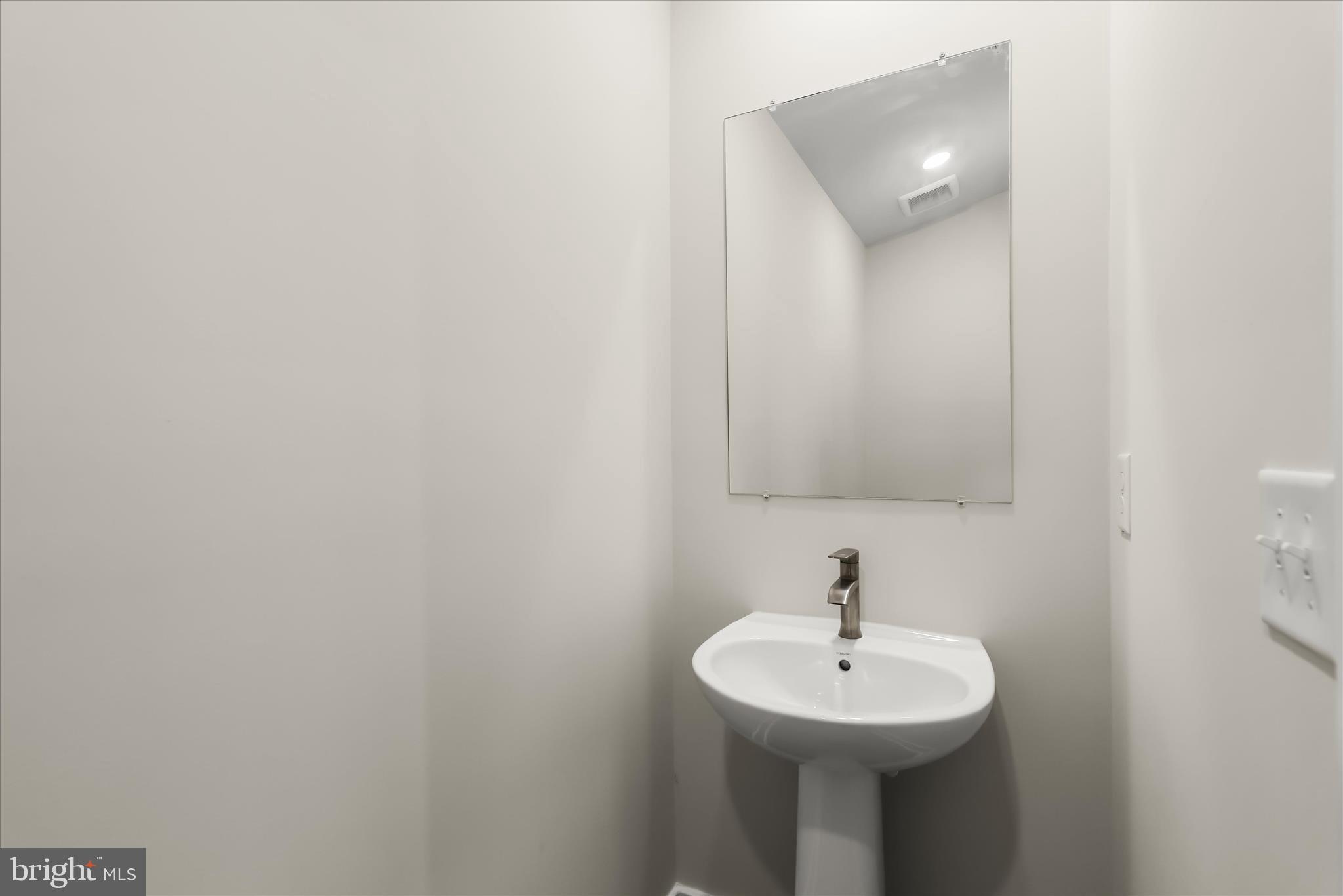 304 Sweetbay Road Essex, MD 21221 - Photo 38 of 66 a sink and a mirror