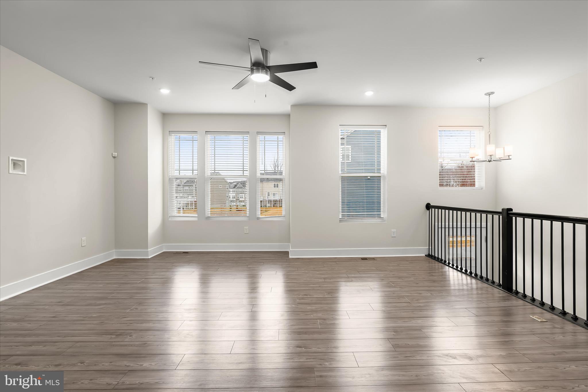 304 Sweetbay Road Essex, MD 21221 - Photo 6 of 66 a view of an empty room with wooden floor and a window