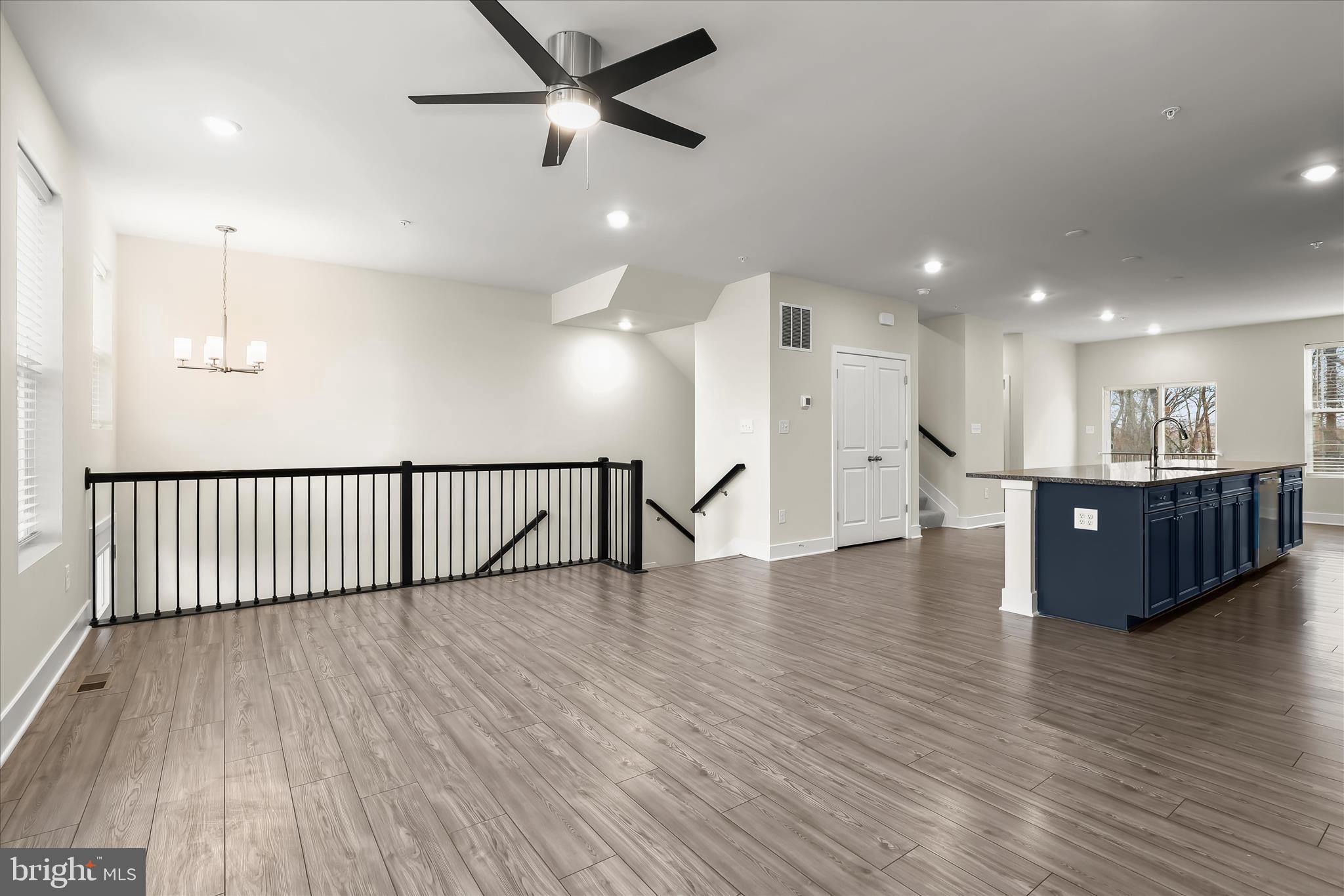 304 Sweetbay Road Essex, MD 21221 - Photo 7 of 66 a view of an empty room with wooden floor and a ceiling fan