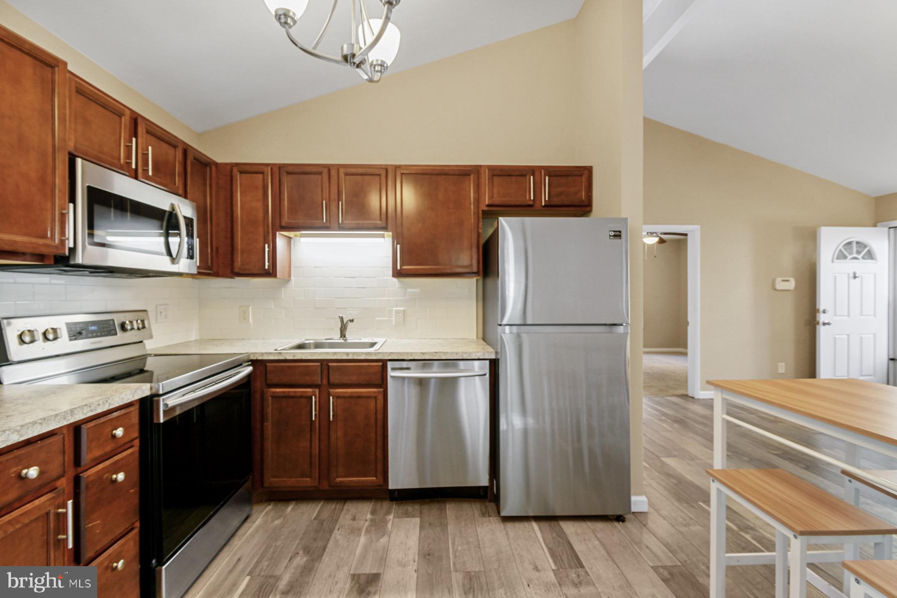 3 Birdnest Drive Ocean Pines, MD 21811 - Photo 11 of 29 a kitchen with stainless steel appliances granite countertop a refrigerator stove a sink dishwasher and microwave