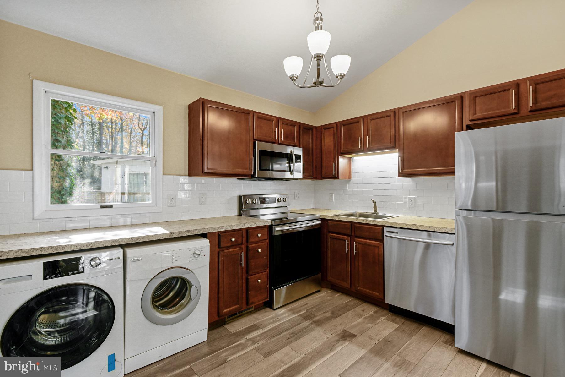 3 Birdnest Drive Ocean Pines, MD 21811 - Photo 12 of 29 a kitchen with refrigerator cabinets and wooden floor
