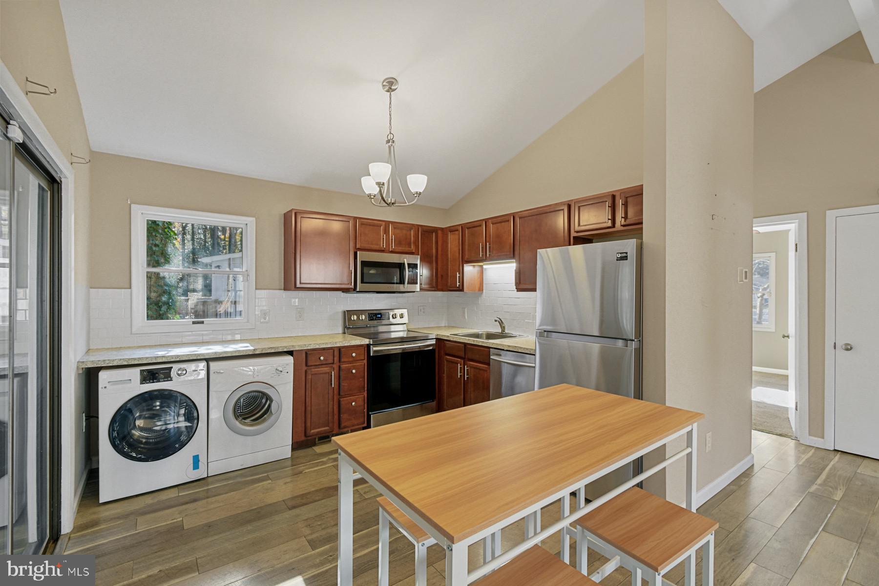 3 Birdnest Drive Ocean Pines, MD 21811 - Photo 8 of 29 a kitchen with stainless steel appliances granite countertop a refrigerator a stove a sink dishwasher a oven with a dining table and chairs
