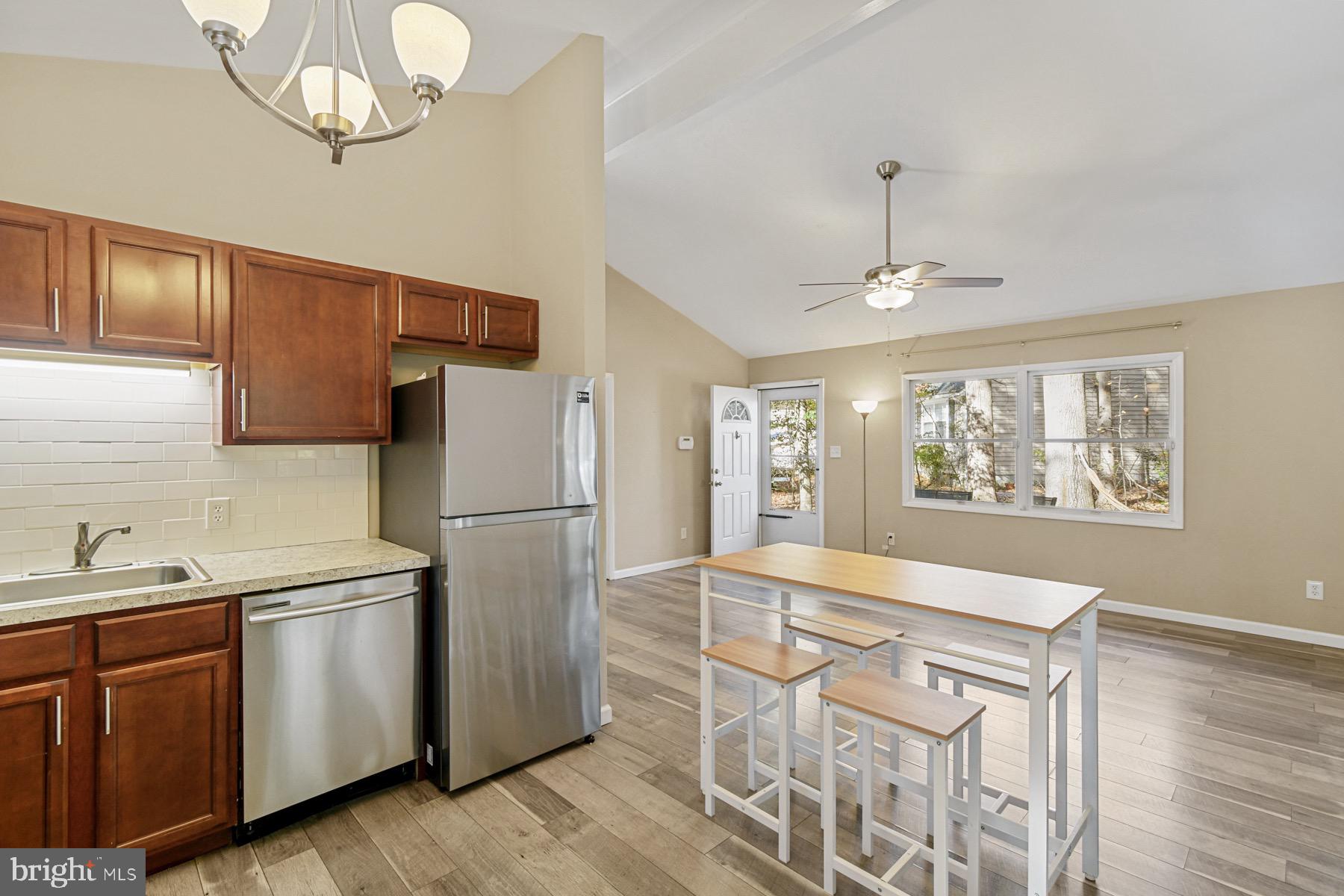 3 Birdnest Drive Ocean Pines, MD 21811 - Photo 9 of 29 a kitchen with stainless steel appliances granite countertop a sink a stove a refrigerator cabinets and dining table