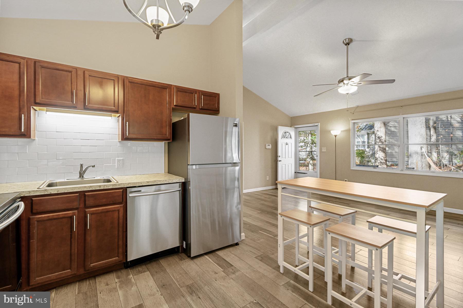 3 Birdnest Drive Ocean Pines, MD 21811 - Photo 10 of 29 a kitchen with stainless steel appliances granite countertop a refrigerator a sink dishwasher a stove and white countertops with wooden floor