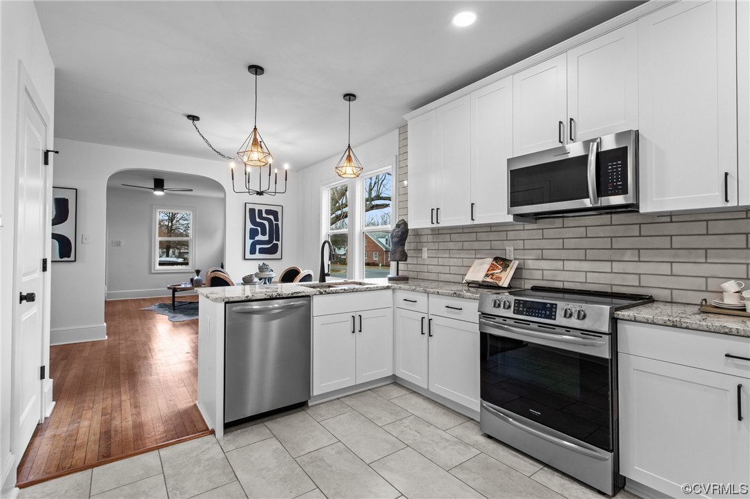 2217 Bailey Drive Henrico, VA 23231 - Photo 6 of 25 a kitchen with stainless steel appliances granite countertop a stove a sink and a microwave