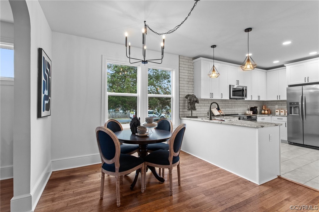2217 Bailey Drive Henrico, VA 23231 - Photo 9 of 25 a kitchen with stainless steel appliances a dining table chairs and wooden floor