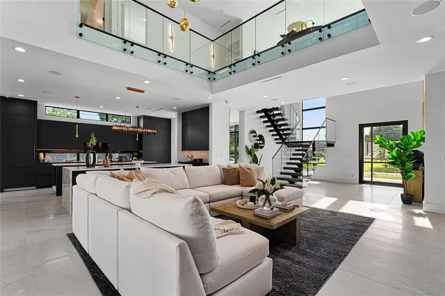 a living room with furniture and a potted plant