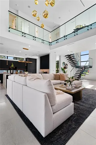 a living room with furniture and a chandelier