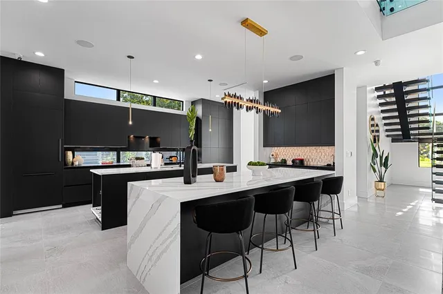 a large kitchen with a table and chairs in it