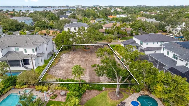 an aerial view of residential houses with outdoor space and swimming pool