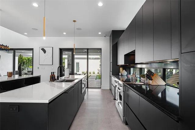 a kitchen with a sink and chairs