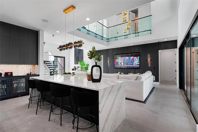 a large kitchen with a counter space a sink stainless steel appliances and cabinets