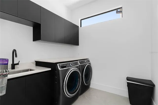 a kitchen with stainless steel appliances kitchen island granite countertop a sink and window