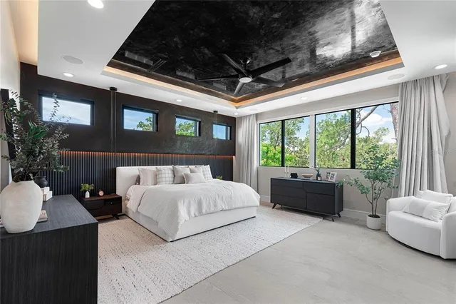 a bedroom with a large bed and a flat tv screen