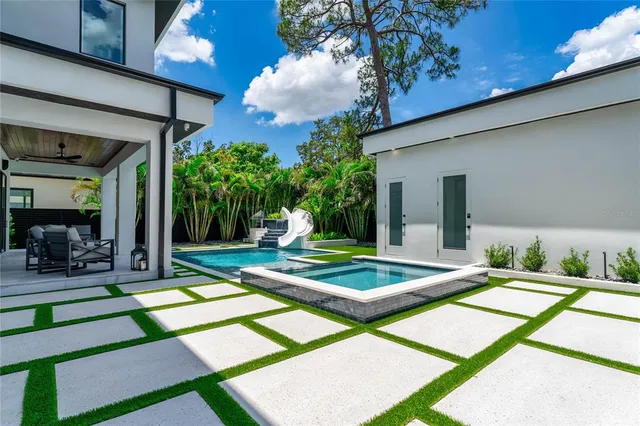a view of a house with backyard and a patio