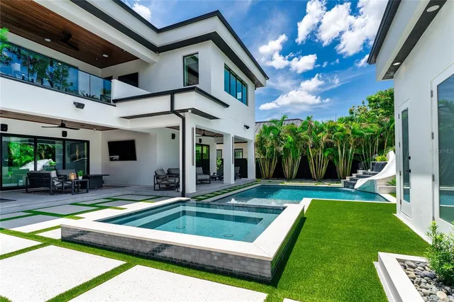 a view of backyard with swimming pool