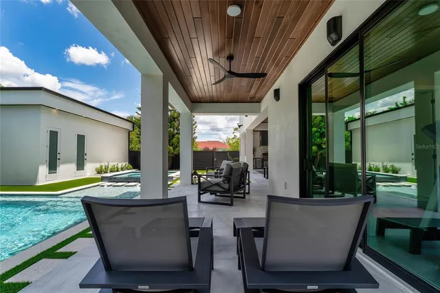 a view of a patio with a table chairs and a backyard