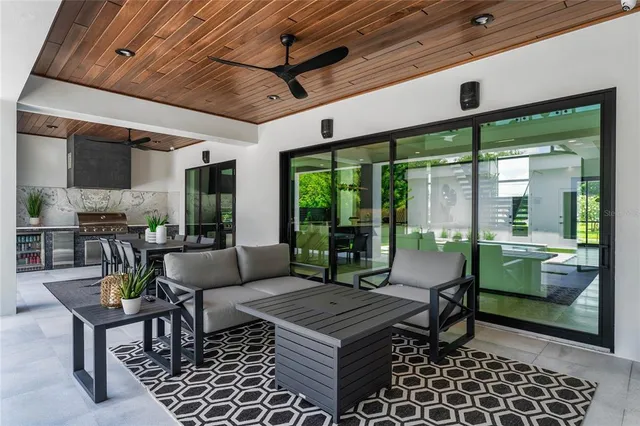 a view of a dining room with furniture a chandelier and wooden floor