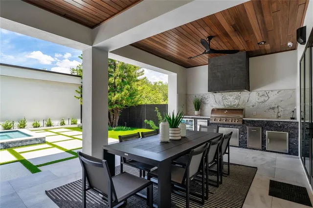 a view of an outdoor dining space with furniture and wooden floor