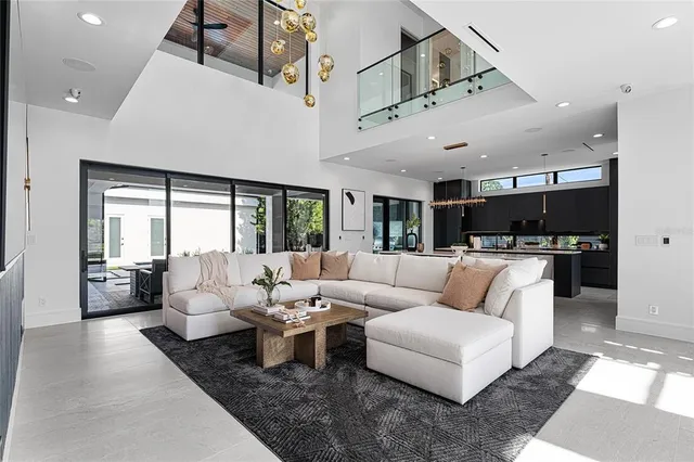 a living room with furniture and view of kitchen