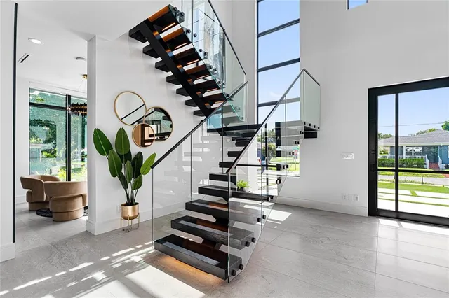 an entryway in front of a house with wooden floor