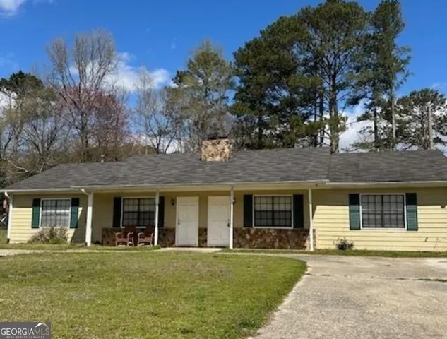 front view of a brick house with a yard