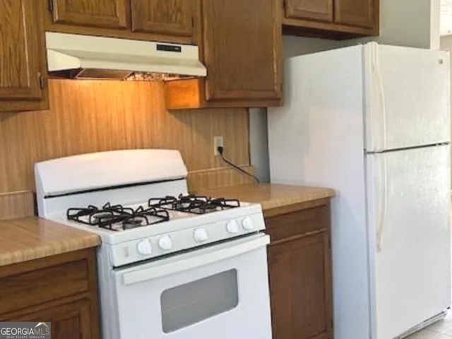 a kitchen with a stove and a refrigerator
