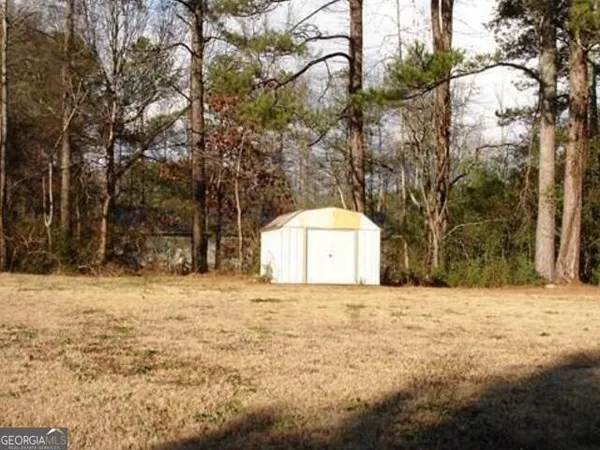 a view of a white house with a yard