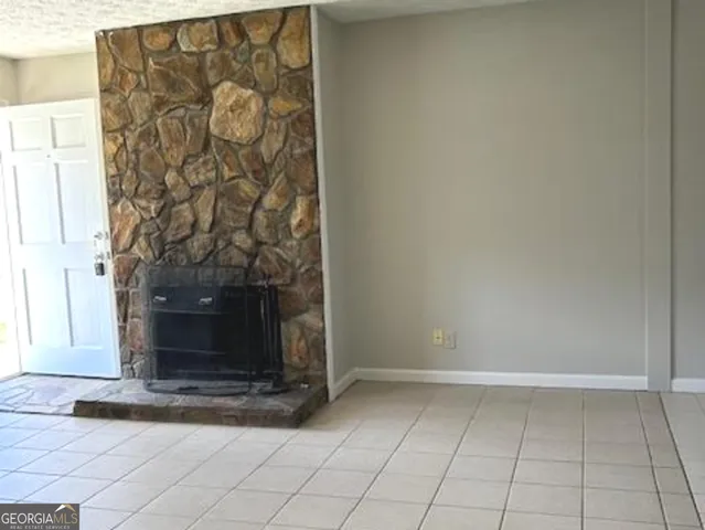 a view of empty room with fireplace
