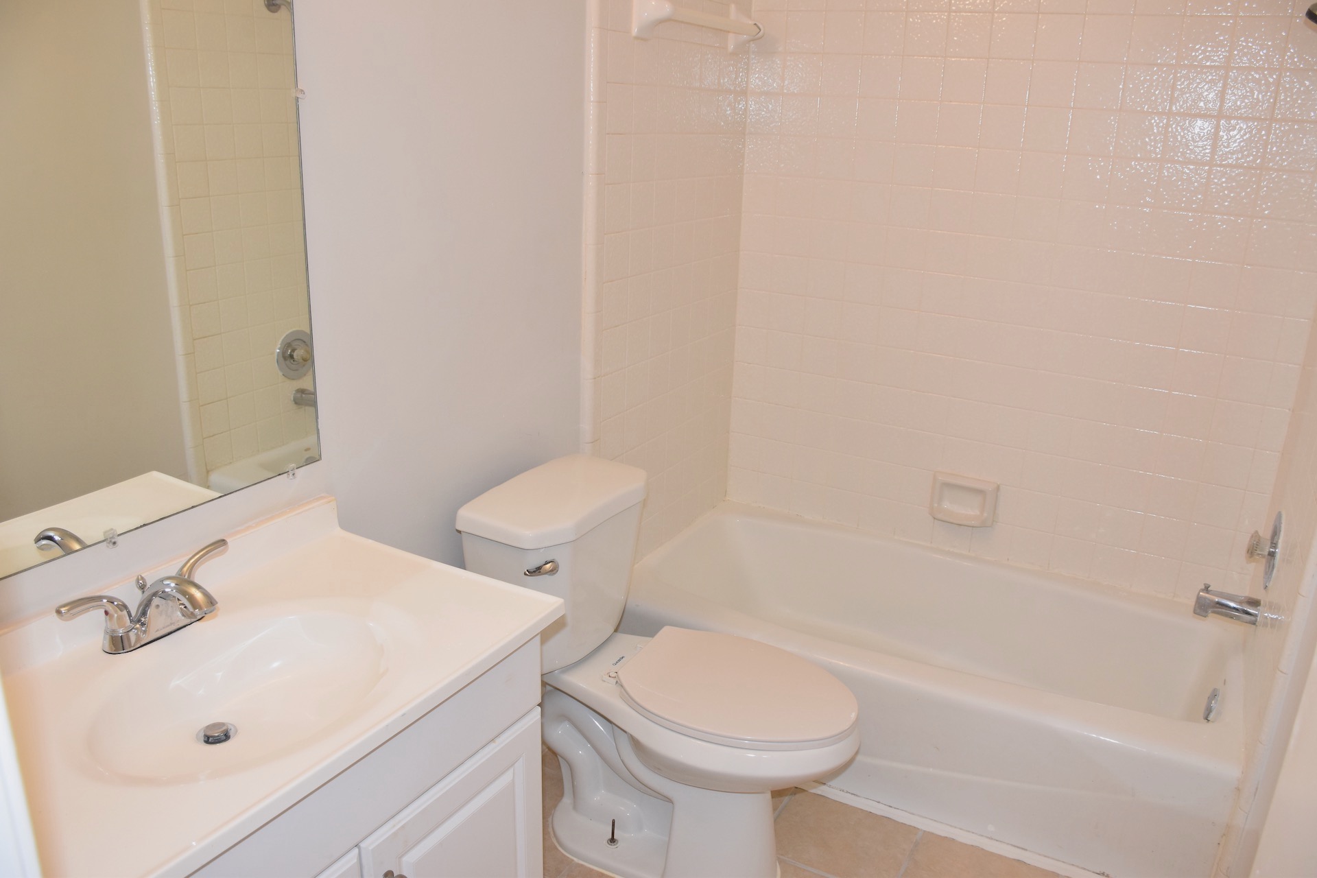 1810 Rawhide Loop Round Rock, TX 78681 - Photo 23 of 29 Bathroom featuring a white vanity with an integrated sink, chrome faucet, and a wall-mounted mirror