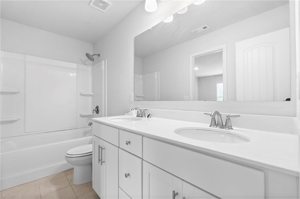 42 Citrine Way Acworth, GA 30101 - Photo 38 of 55 a bathroom with a double vanity sink toilet and a bathtub