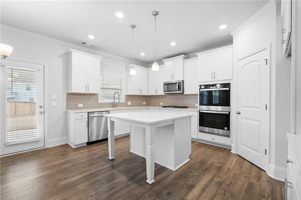 42 Citrine Way Acworth, GA 30101 - Photo 8 of 55 a kitchen with white cabinets and stainless steel appliances