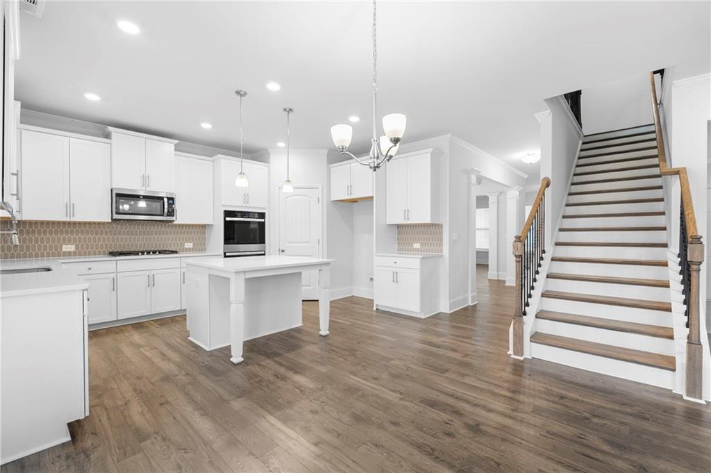 42 Citrine Way Acworth, GA 30101 - Photo 9 of 55 a open kitchen with white cabinets and stainless steel appliances